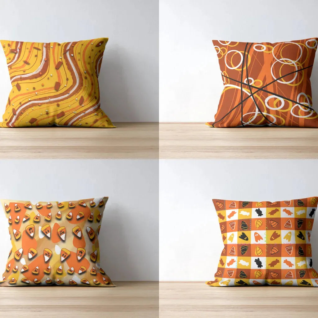Mockup of four throw pillows side-by-side, showcasing the repeating Candy Corn pattern on fabric for home decor.