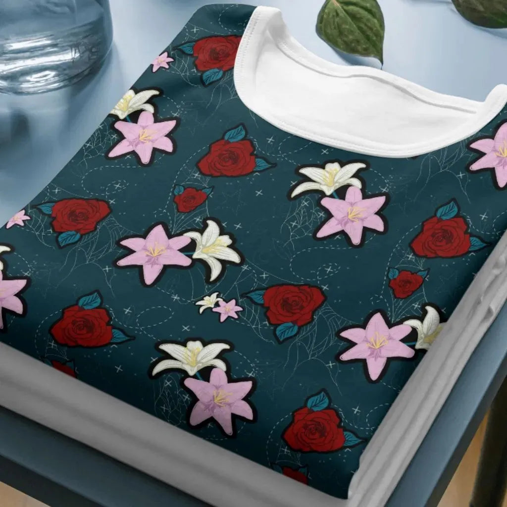 Close-up mockup of the dark floral pattern printed on a folded short-sleeved t-shirt.