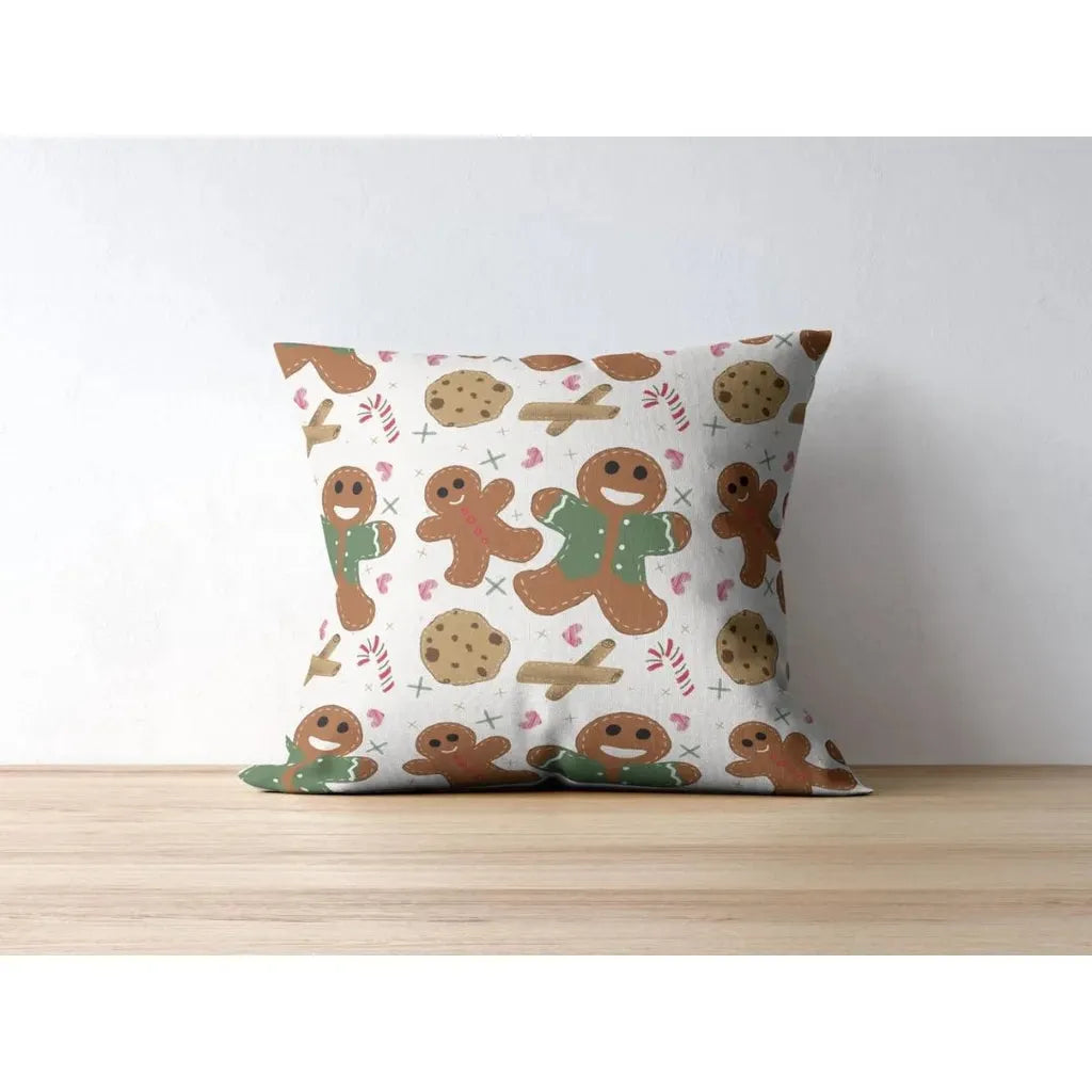 Square throw pillow mockup displaying the repeating winter holiday pattern of cookies and candy canes.