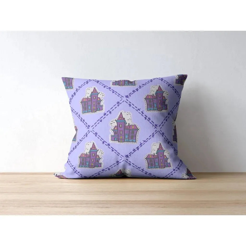 Square throw pillow mockup with a fun, repeating pattern of whimsical haunted houses on a light purple background.