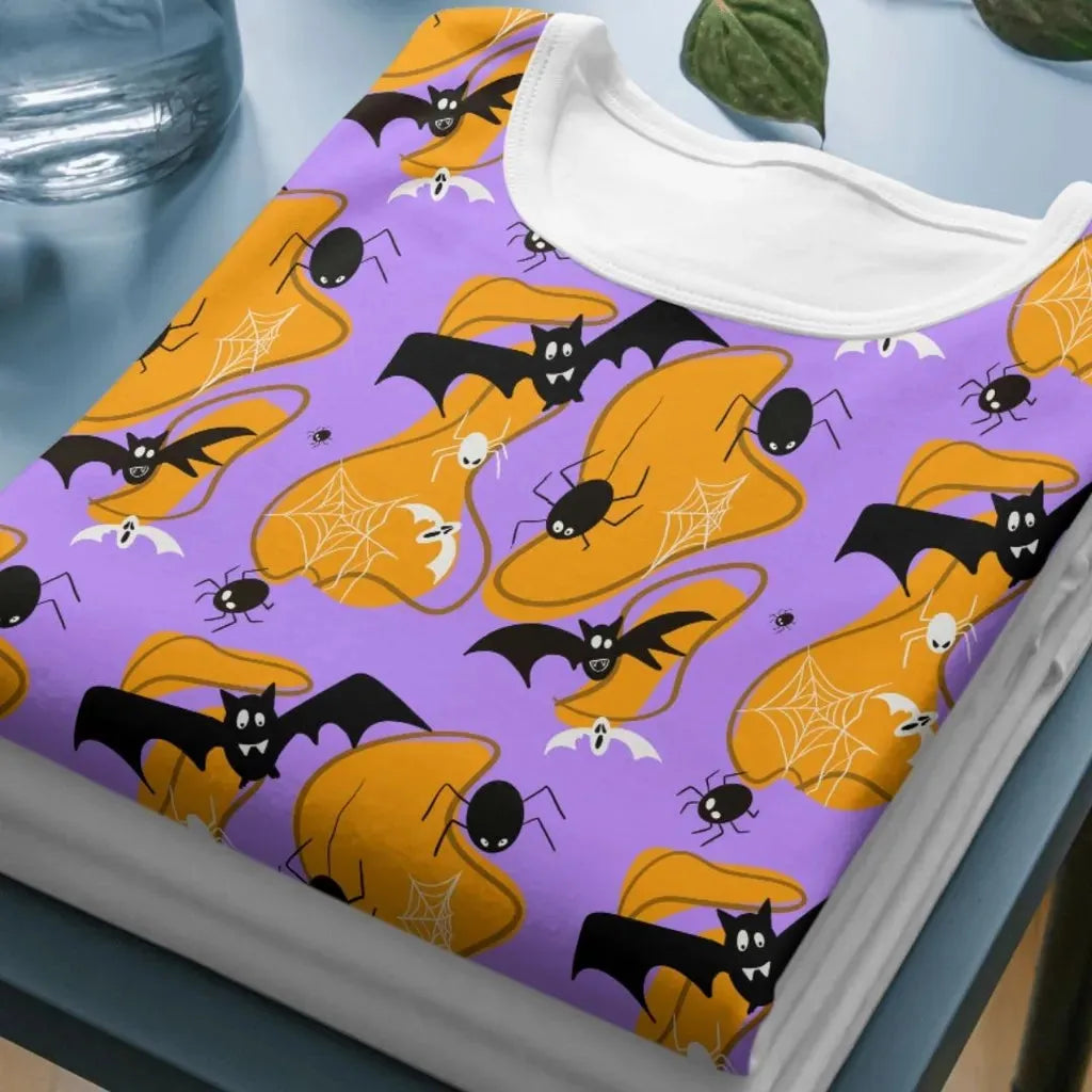 Mockup of a t-shirt showing the all-over print of the wonky bats seamless design, ideal for spooky sublimation printing.