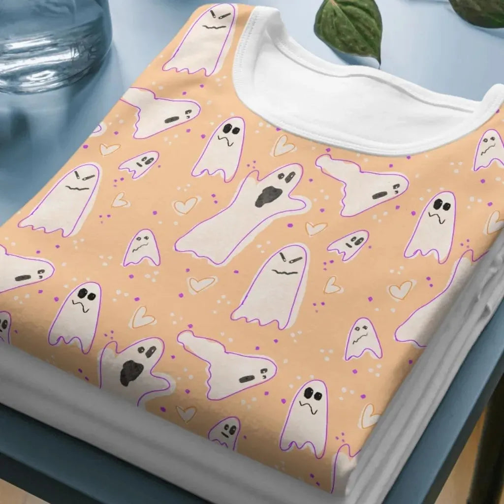 Mockup of a t-shirt showing the all-over print of the wonky ghosts seamless design, ideal for spooky sublimation printing.