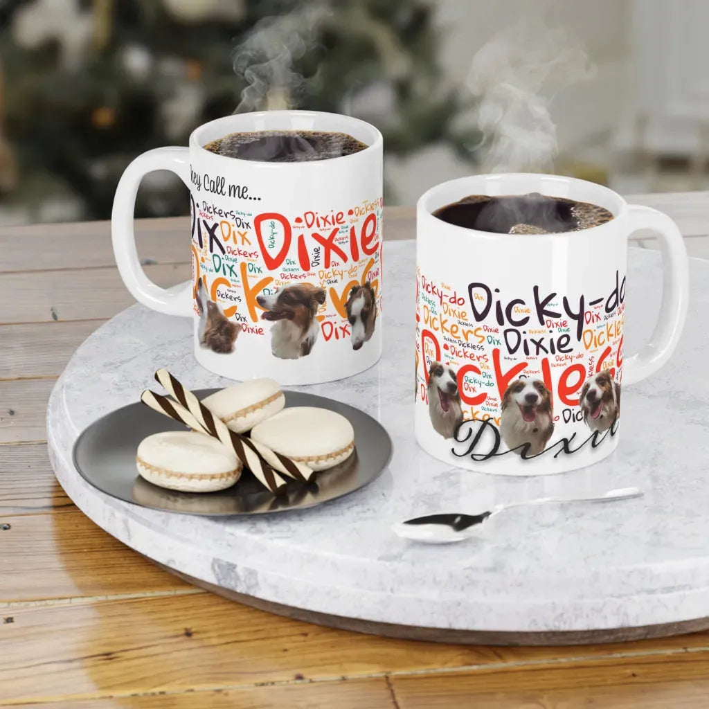 Two white custom mugs with colorful dog designs, steaming coffee inside, served with cookies on a table.