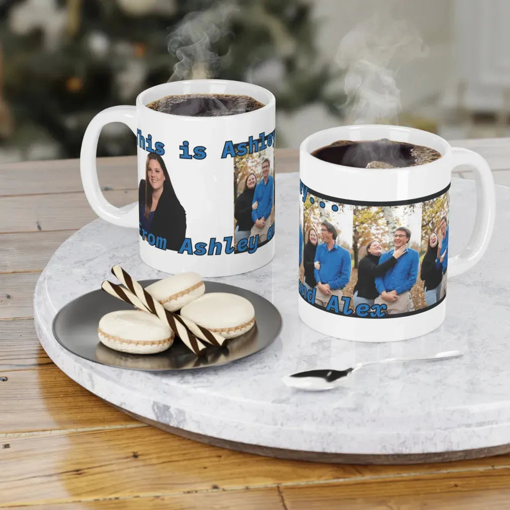 Two personalized ceramic mugs with colorful dog designs, steaming coffee inside, on a marble tray with cookies.